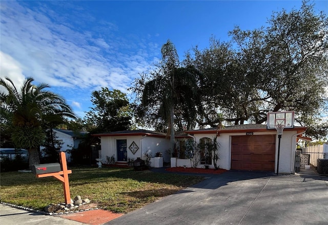 view of front of home with a front yard and a garage