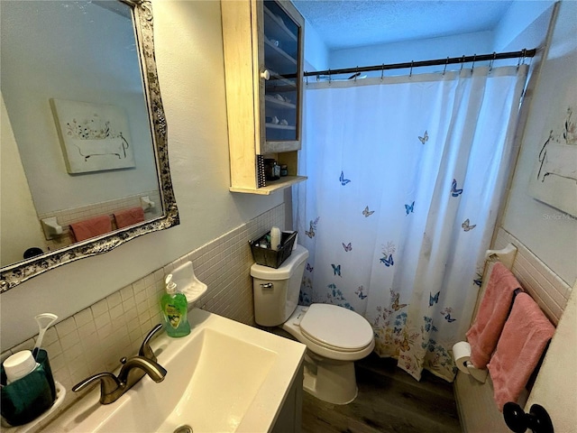 bathroom featuring walk in shower, a textured ceiling, sink, hardwood / wood-style flooring, and toilet