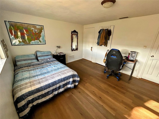 bedroom with dark wood-type flooring