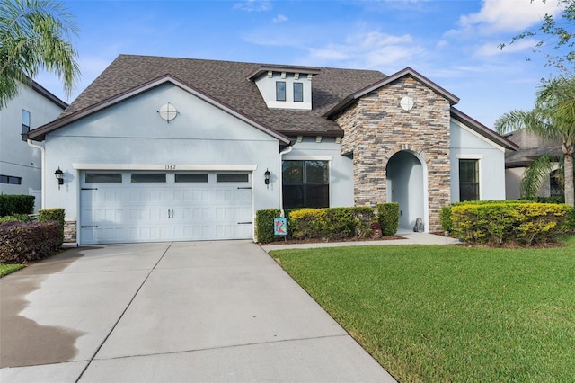 view of front of home featuring a front lawn and a garage