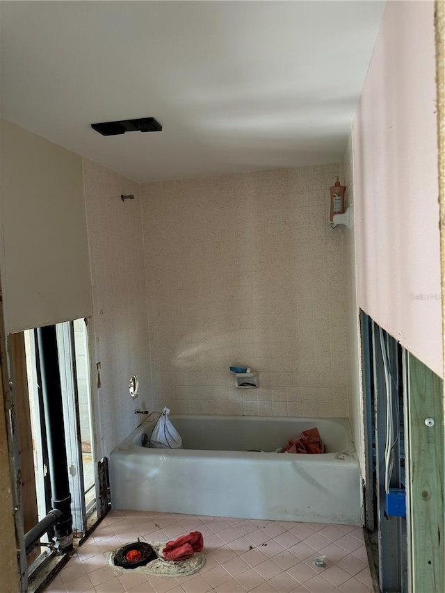 bathroom featuring a tub and tile patterned flooring