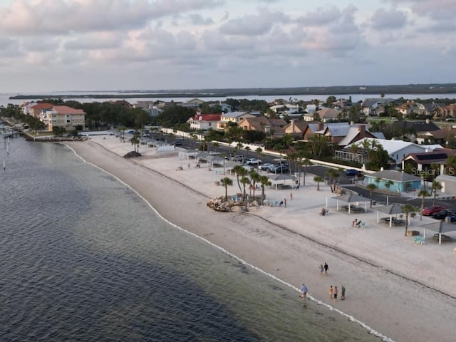 bird's eye view featuring a water view and a beach view