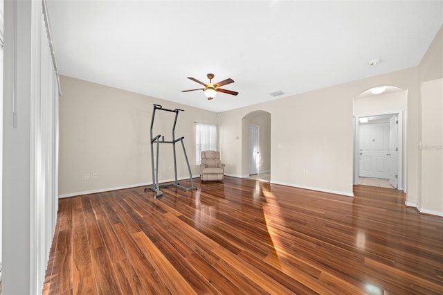 empty room with ceiling fan and dark hardwood / wood-style flooring