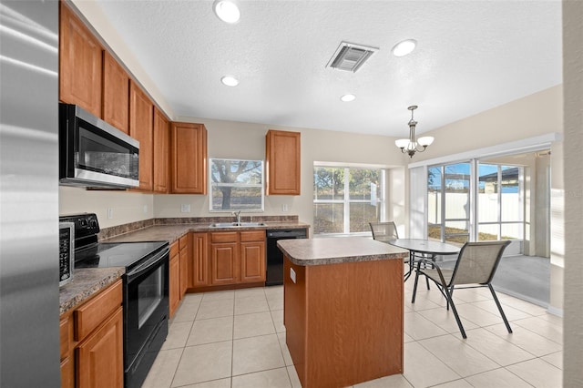 kitchen with a center island, an inviting chandelier, black appliances, sink, and hanging light fixtures