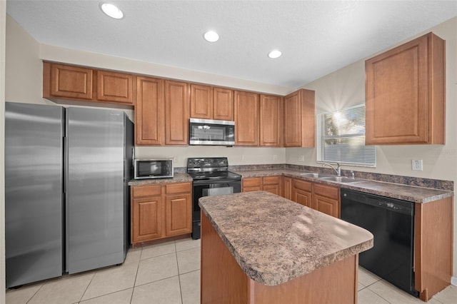 kitchen featuring sink, a center island, black appliances, and light tile patterned floors