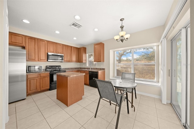 kitchen featuring a center island, an inviting chandelier, pendant lighting, light tile patterned flooring, and black appliances