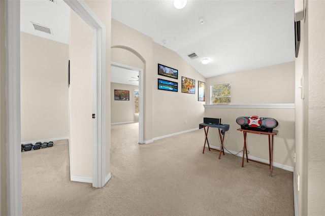 rec room featuring light colored carpet and vaulted ceiling