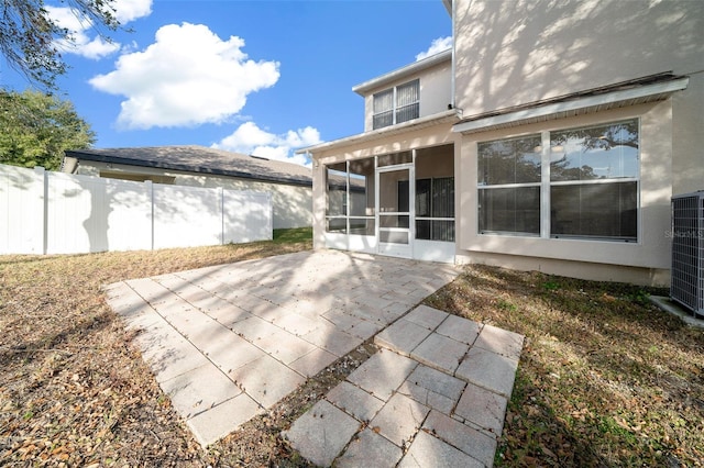 view of patio featuring central AC unit and a sunroom