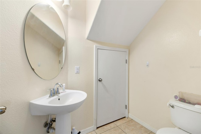 bathroom with sink, tile patterned flooring, and toilet