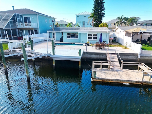 dock area featuring a water view and a patio