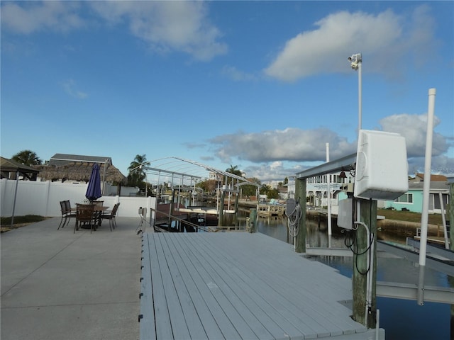 wooden deck with a water view and a dock