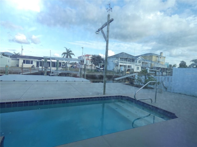 view of pool with a water view