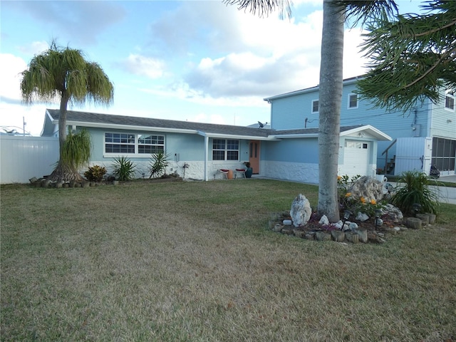 back of house featuring a lawn and a garage