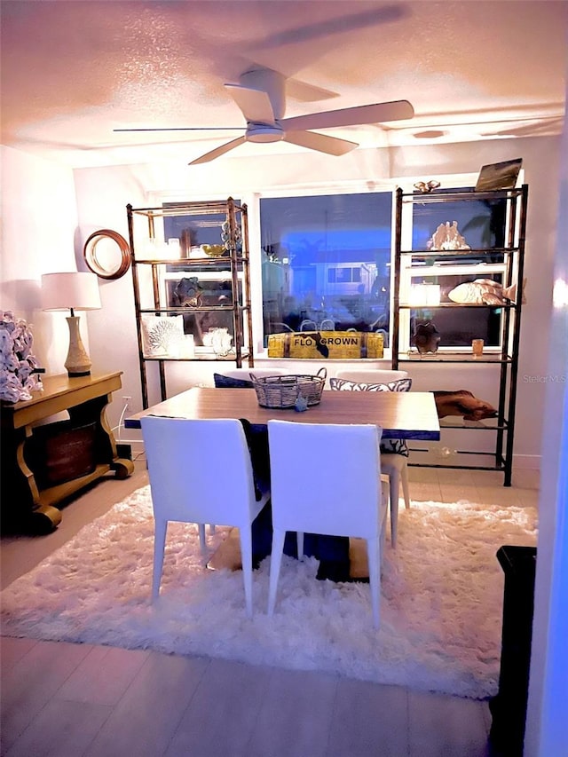 dining room featuring ceiling fan and a textured ceiling