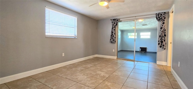 tiled empty room with ceiling fan