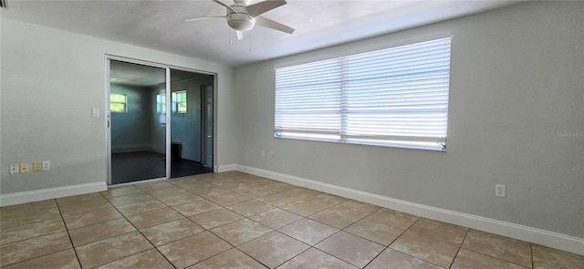 unfurnished bedroom featuring light tile patterned flooring, a closet, and ceiling fan