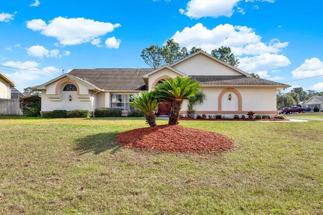 ranch-style home featuring a front yard