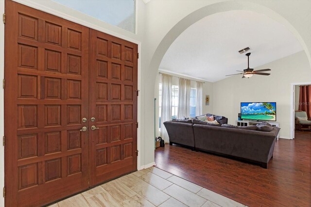 entryway featuring ceiling fan, light wood-type flooring, and lofted ceiling