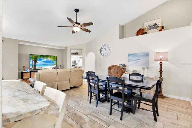 dining area with ceiling fan and vaulted ceiling