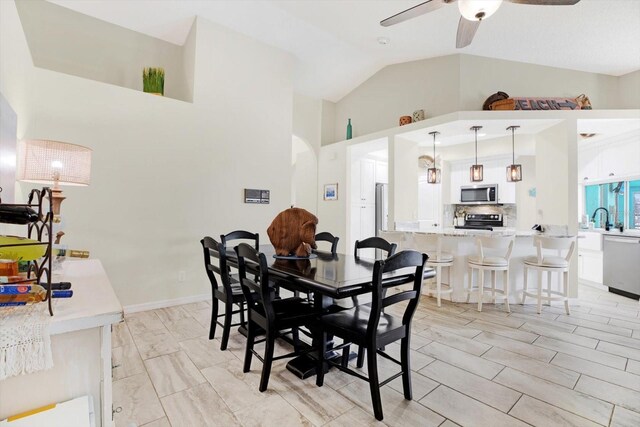 dining area with ceiling fan and lofted ceiling