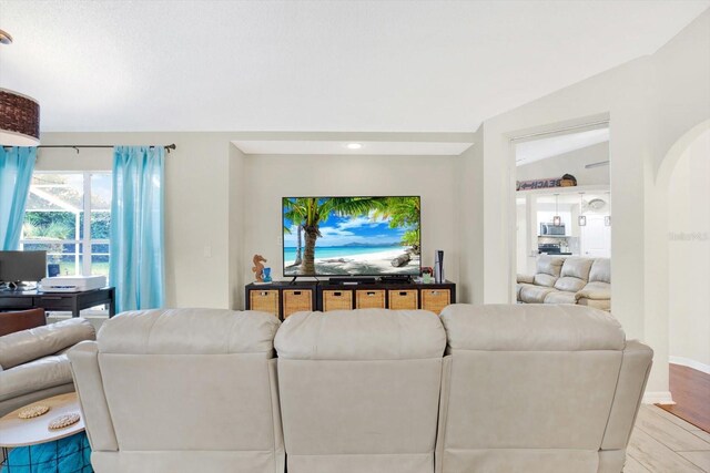 living room featuring light hardwood / wood-style floors and lofted ceiling