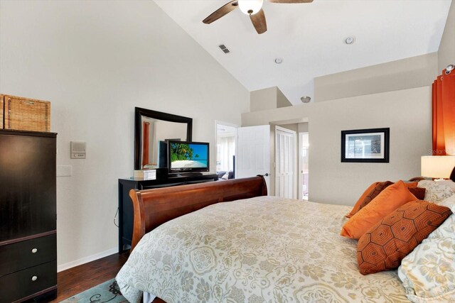 bedroom featuring dark hardwood / wood-style floors, high vaulted ceiling, and ceiling fan