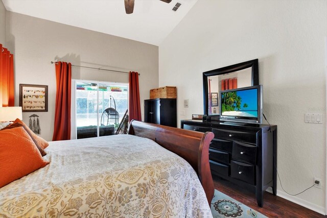 bedroom featuring ceiling fan, dark hardwood / wood-style floors, lofted ceiling, and access to outside