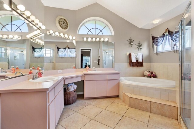 bathroom featuring tile patterned floors, vanity, and shower with separate bathtub