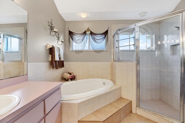 bathroom with plus walk in shower, tile patterned flooring, and vanity