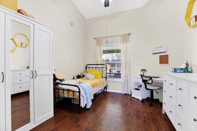 bedroom featuring ceiling fan, dark hardwood / wood-style flooring, and vaulted ceiling