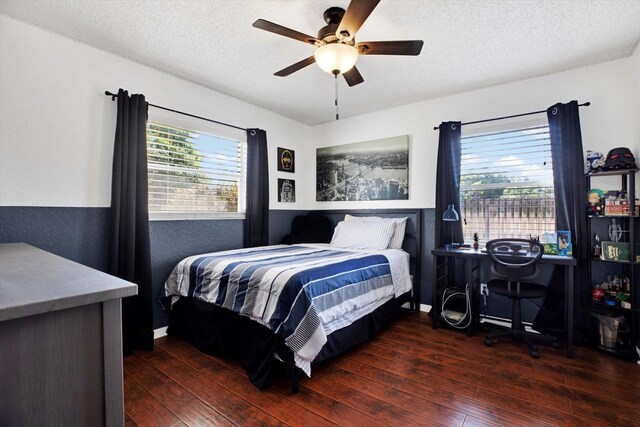 bedroom featuring a textured ceiling, ceiling fan, and dark wood-type flooring