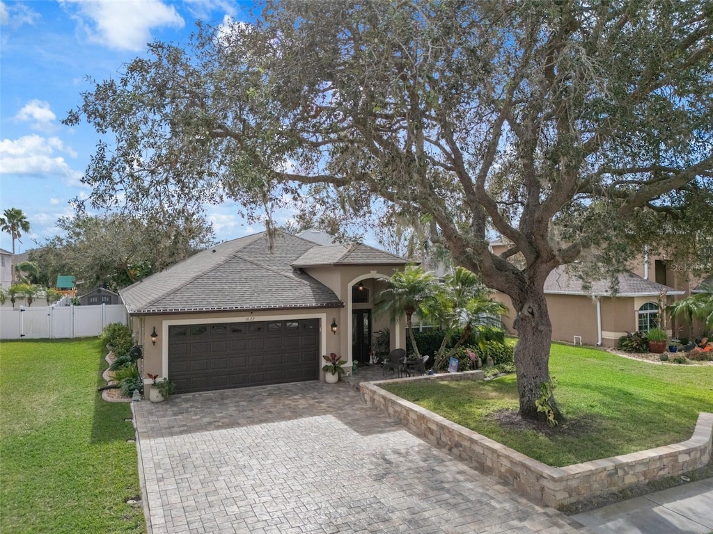 view of front facade with a front lawn and a garage