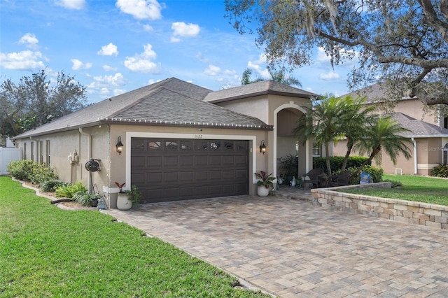 view of front of property with a front yard and a garage