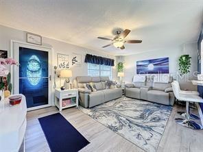 living room with hardwood / wood-style flooring and ceiling fan