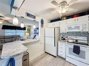 kitchen with white cabinets, decorative light fixtures, ceiling fan, and white appliances