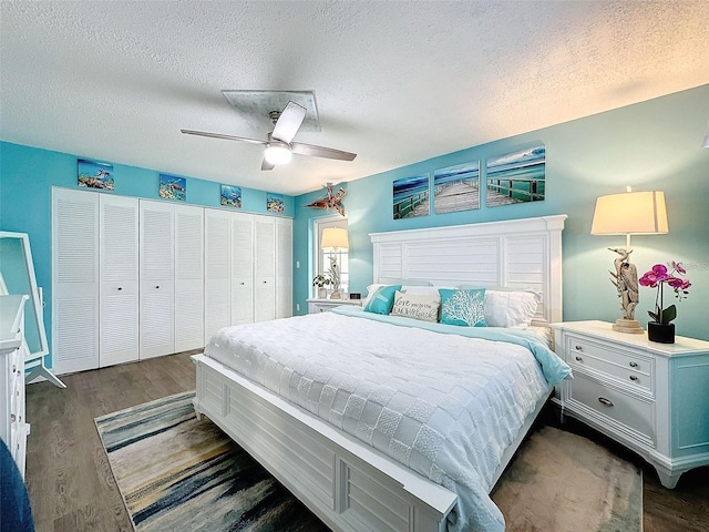 bedroom with ceiling fan, dark hardwood / wood-style floors, a textured ceiling, and a closet