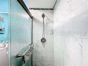 bathroom with a shower with shower door