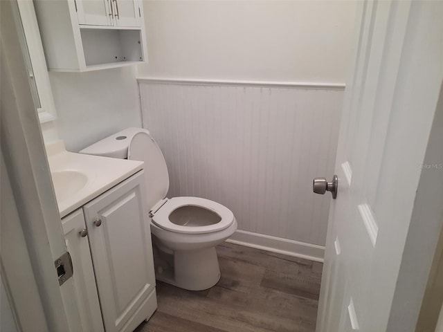 bathroom featuring hardwood / wood-style flooring, vanity, and toilet