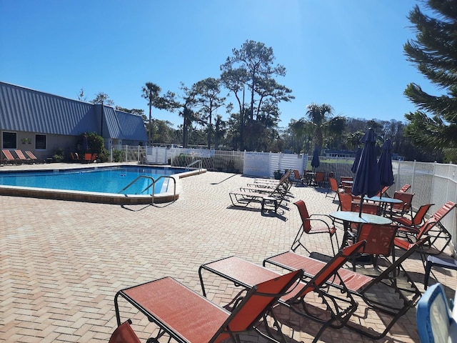 view of swimming pool with a patio