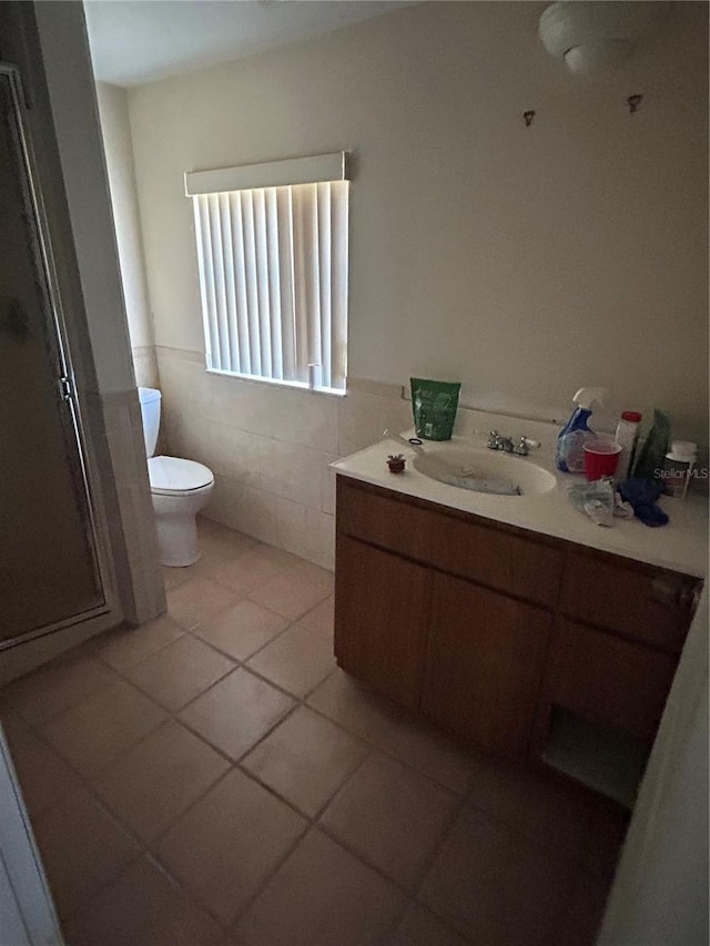 bathroom featuring tile walls, tile patterned floors, vanity, and toilet