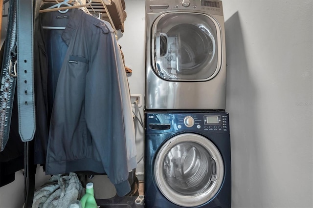 clothes washing area featuring stacked washer / drying machine