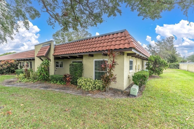 view of side of home with a yard