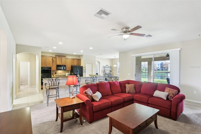 living room featuring ceiling fan and light tile patterned floors