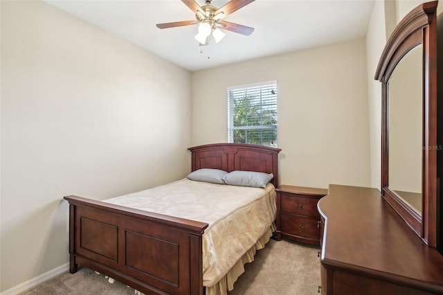 bedroom featuring ceiling fan and light carpet