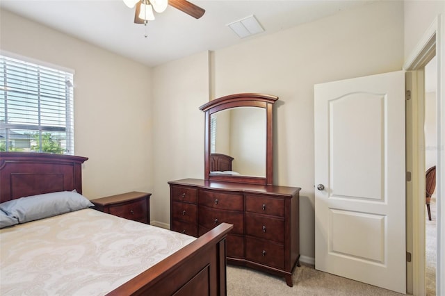 bedroom featuring ceiling fan and light carpet