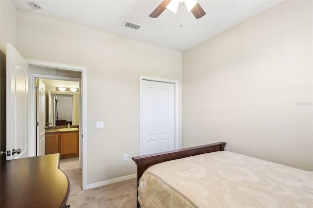 bedroom with ceiling fan, a closet, light carpet, and sink