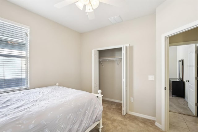 bedroom featuring a closet, ceiling fan, and light colored carpet