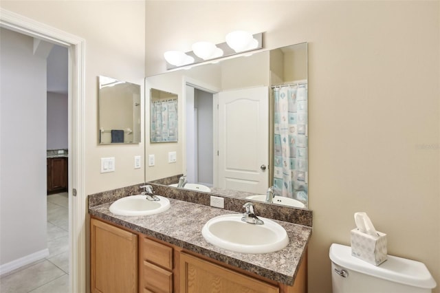 bathroom with tile patterned flooring, vanity, and toilet