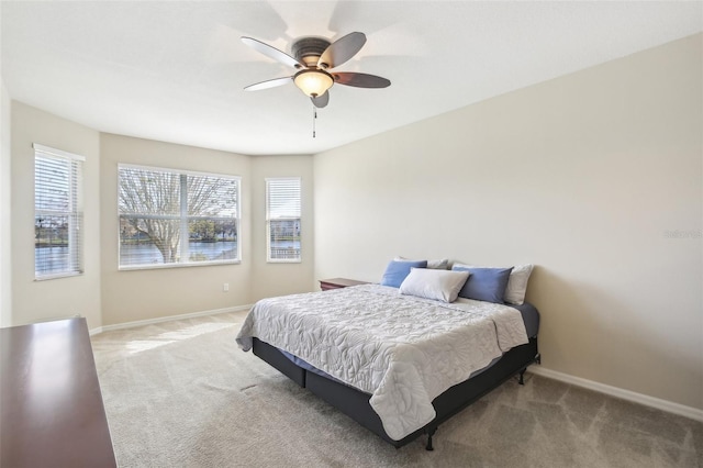 bedroom featuring light carpet and ceiling fan