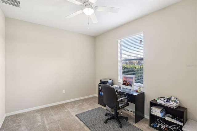 carpeted office featuring ceiling fan